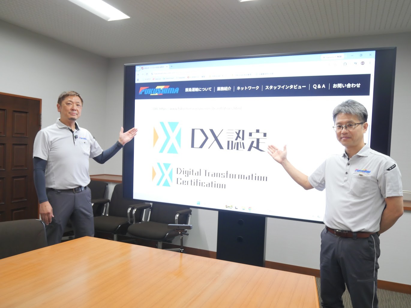 DX認定のロゴを示す服島社長㊧と樋野経営戦略室長