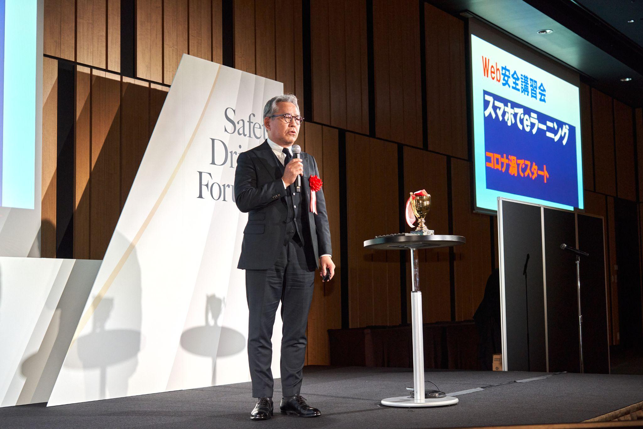 SDA2025の授賞式でプレゼンする占部取締役