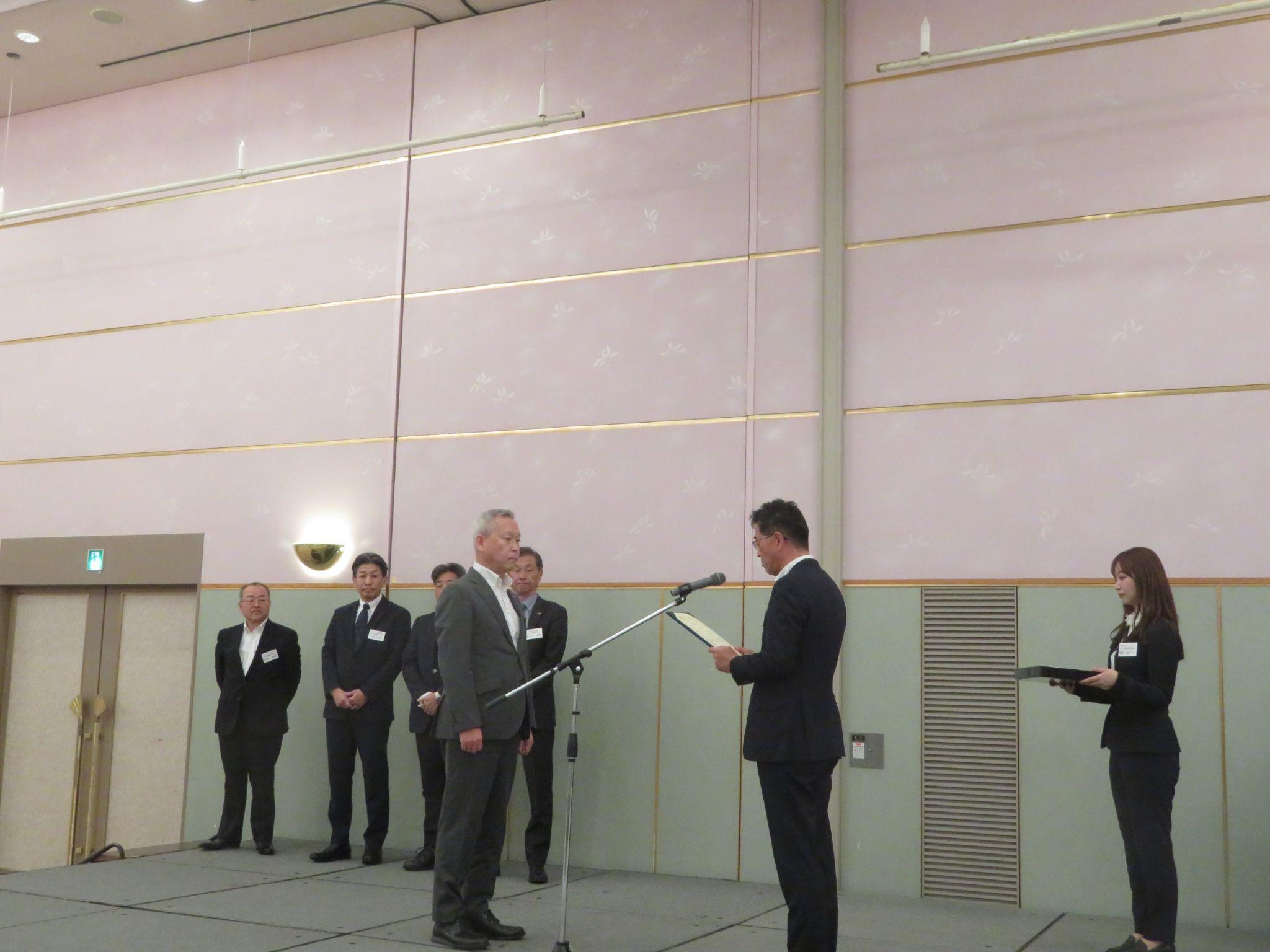 物流評価制度に基づく表彰で賞状を贈呈する服部社長㊨