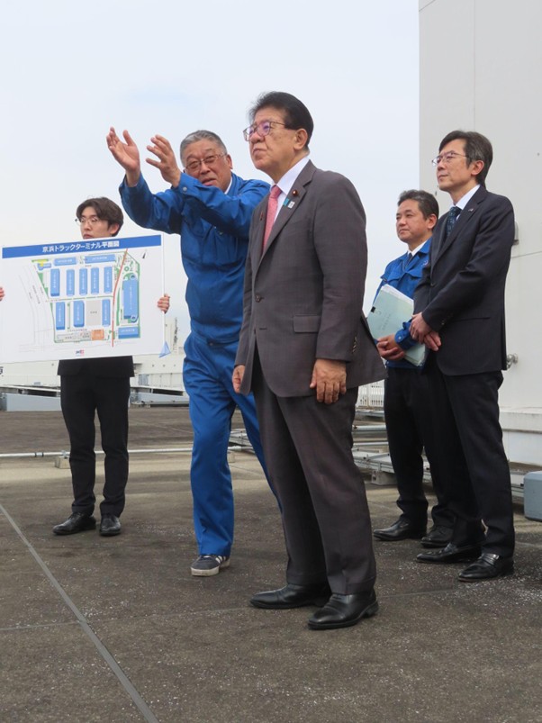 JMTの井上京浜TTマネージャー（左から2人目）から説明を受ける金子国交相（右隣）<br>