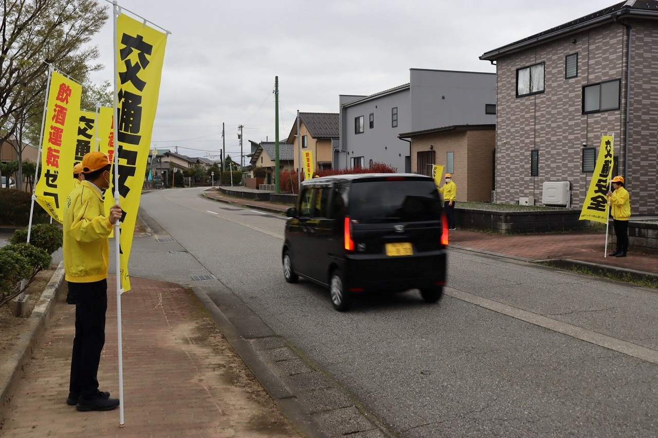 道路の両側に立ち通行車両にアピール