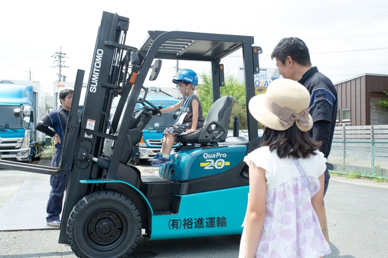 フォークリフトの運転席に乗る子ども